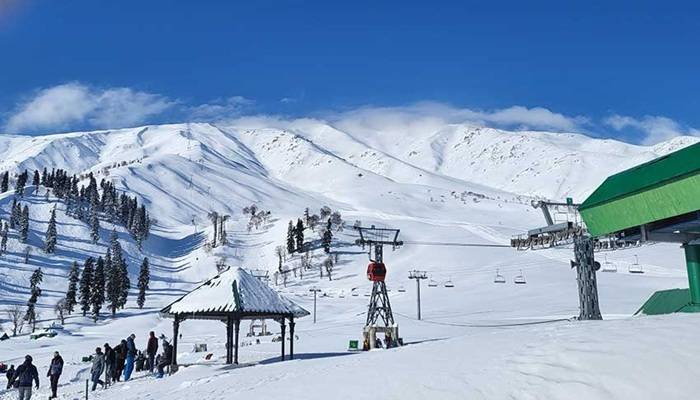 Tourists enjoying panoramic views at Khilanmarg Gulmarg